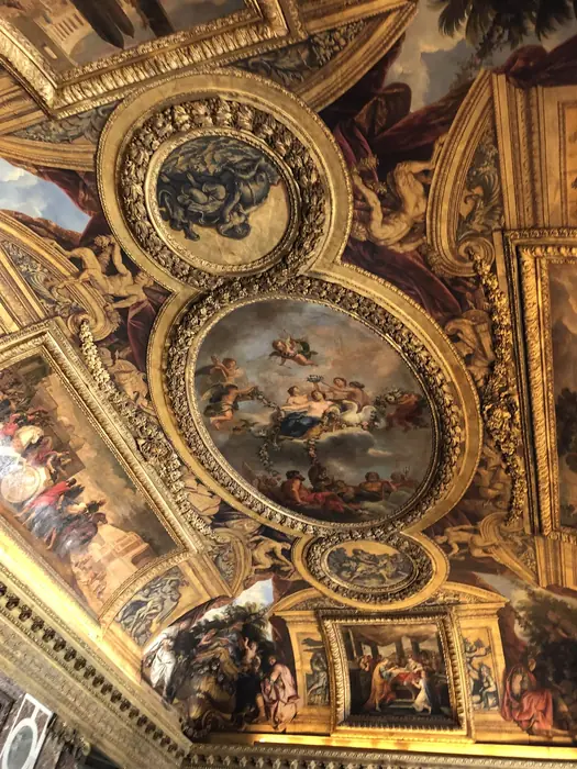Looking up — gold, plaster and paint across a single ceiling.