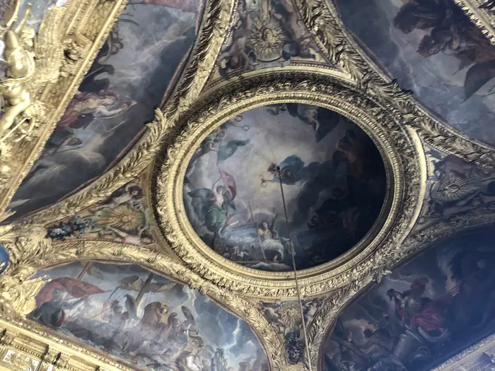 Allegory overhead: one of the painted ceiling roundels at Versailles.
