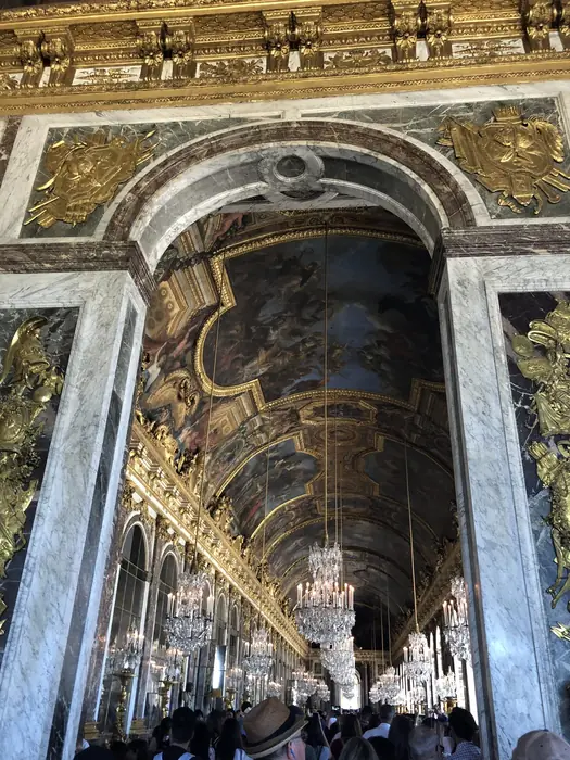 Down the Hall of Mirrors — light, gold and glass without end.