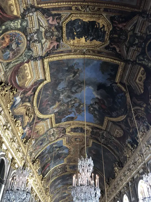 Le Brun's painted history of the reign, overhead in the Hall of Mirrors.